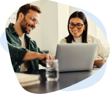 Two engineers collaborating at a laptop in a modern office